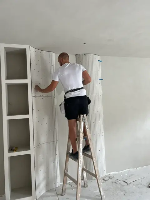 Majstor oblikuje zakrivljeni gipsani stub